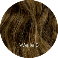 Dunkelaschblonde Extensions gewellt